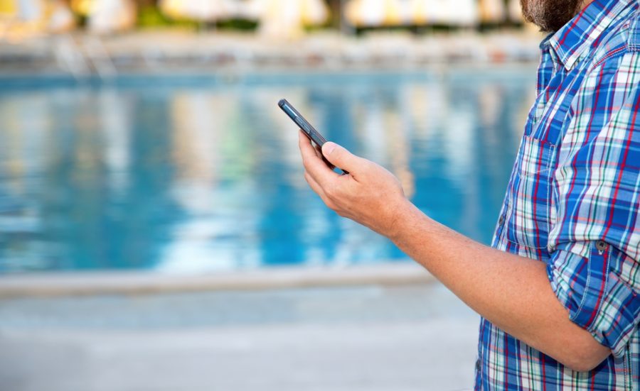 Close-up,-,Male,Hand,Holds,A,Smart,Phone,Against,The